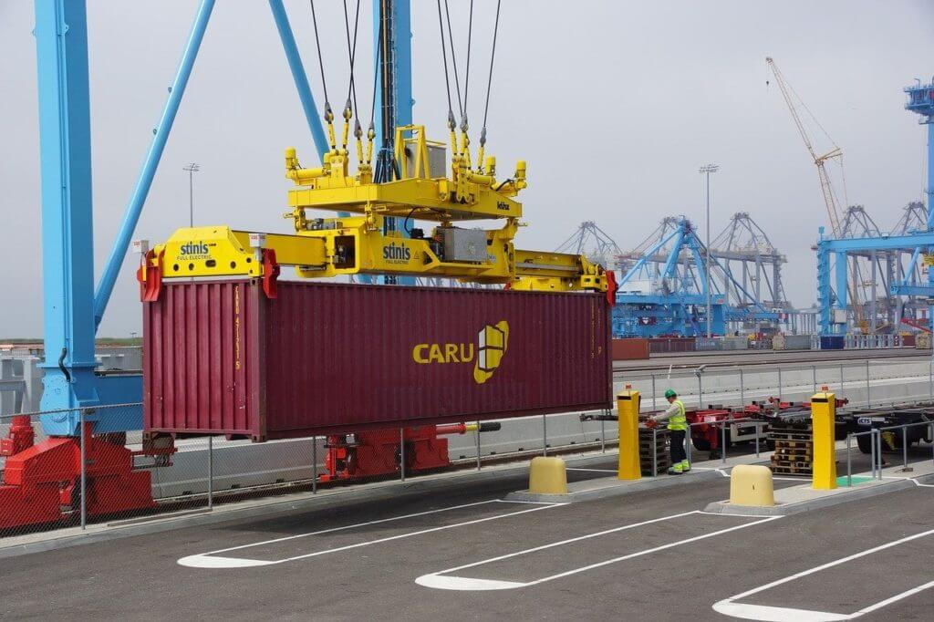 a crane carrying a cargo container
