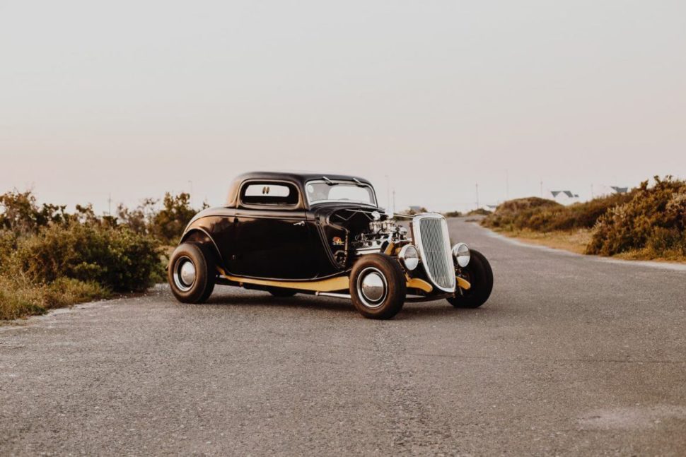 a classic car sitting on the road