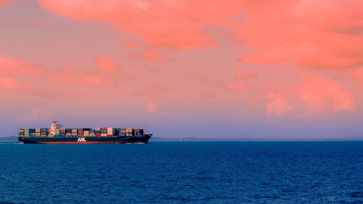 A cargo ship at sunset